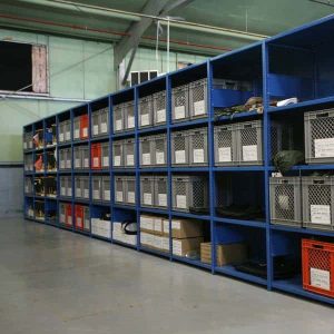 Blue Rousseau spider shelving system storing boxes in a warehouse setting.