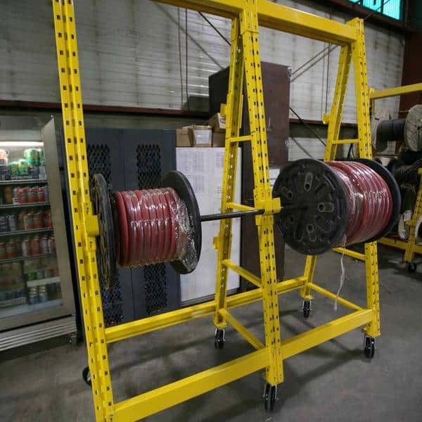 Wire spool rack in a warehouse setting.