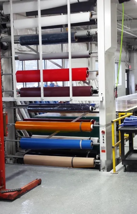 A textile carousel rack with textiles stored in it in a warehouse setting.